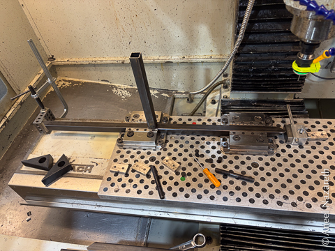 Tubing is held in two vises on the fixture table...